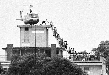 CIA-agent-helps-evacuees up-a ladder onto-an america